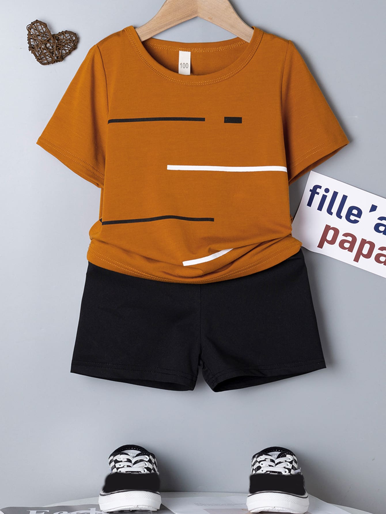 Young Boy Two-Piece Set. Yellow Knitted Striped Printed Round Neck Short Sleeves And Black Casual Knitted Sports Shorts. The Two-Piece Set Is Suitable For Summer.