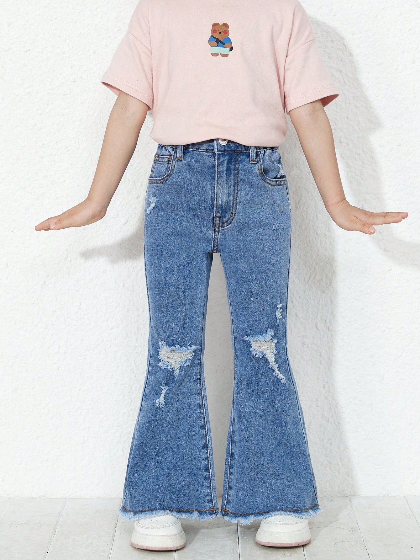 Young Girl Ripped Raw Cut Flare Leg Jeans