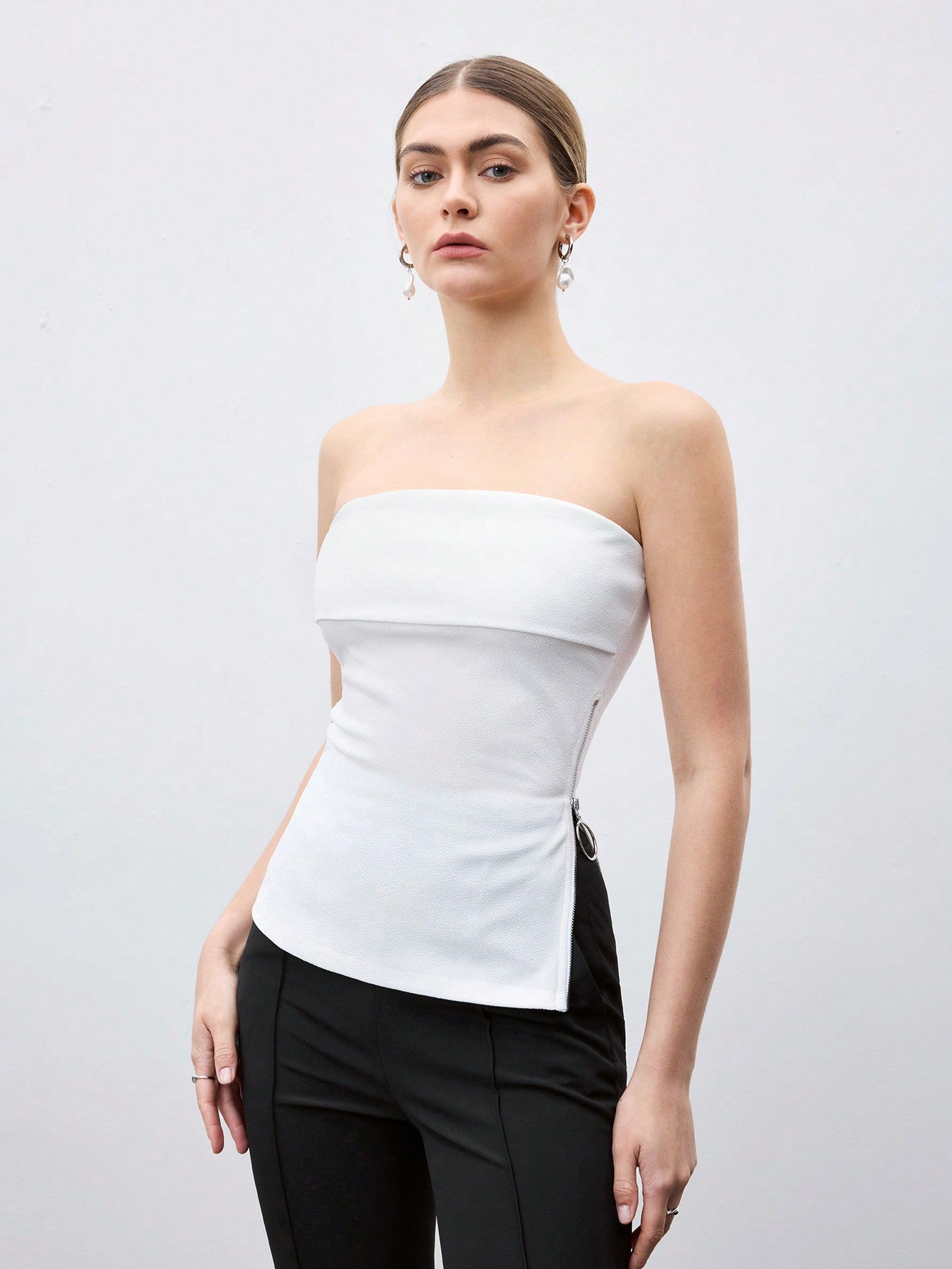 BIZwear Solid Color Side Zipper Crop Top With Strapless Design And Side Slit