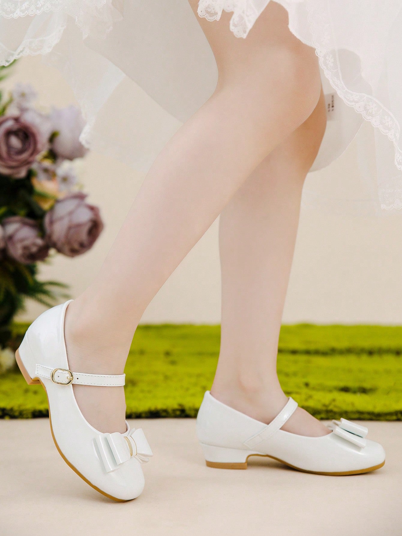 A Pair Of Mary Jane Shoes With Black Bowknot Decoration Matched With A Dress For Children