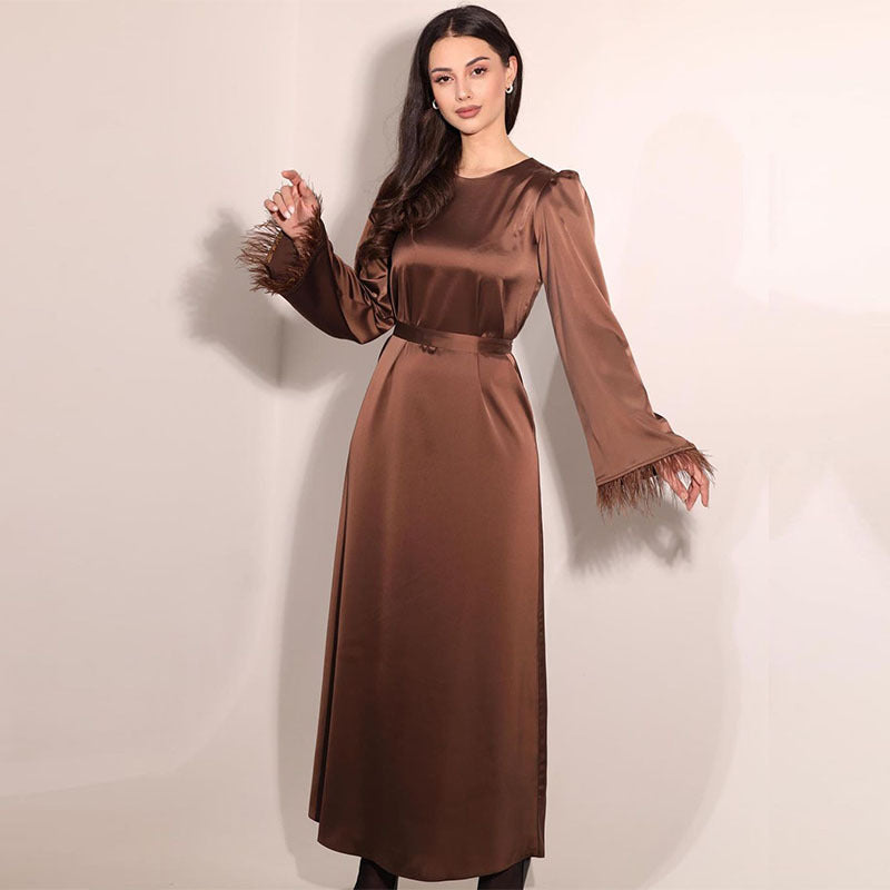 New satin elegant round-neck dress with feather stitch cuffs and long tie-up design.